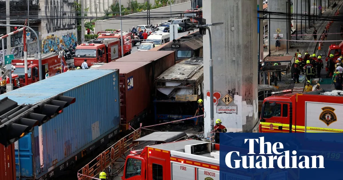Freight train obliterates bus at Bangkok crossing, killing at least eight in fiery crash